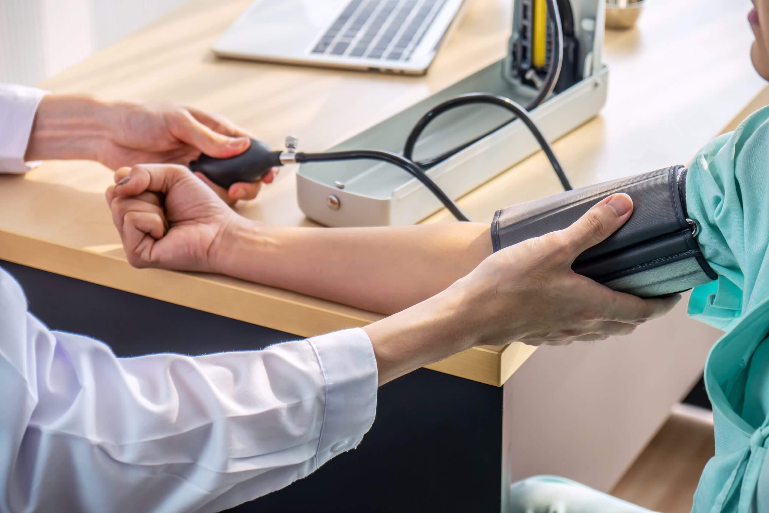 healthcare, hospital and medicine concept - doctor measuring blood pressure from her patient in hospital